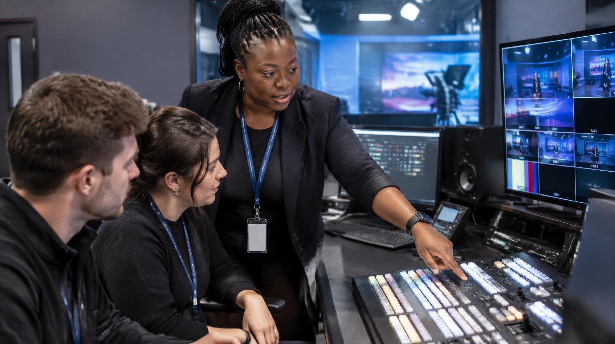 Instructor training a studio team on broadcast equipment on site